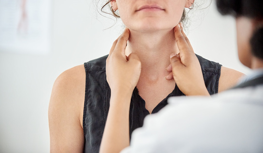 Doctor checking female patient's Thyroid gland in San Diego, CA