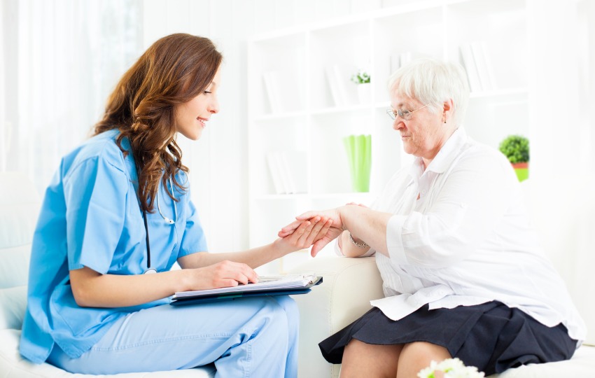 A nurse converses with an elderly woman about psoriasis treatment in San Diego, CA