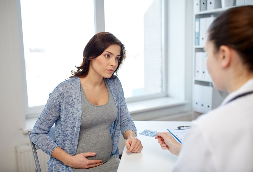 A pregnant woman consults with a doctor about managing high-risk pregnancy in San Diego, CA