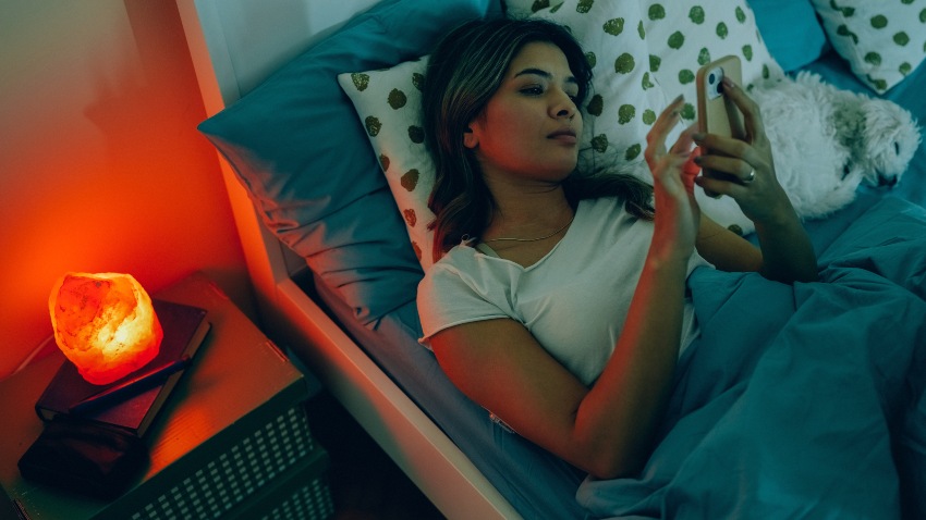 A woman resting in bed representing the link between sleep issues & type 2 diabetes in San Diego, CA