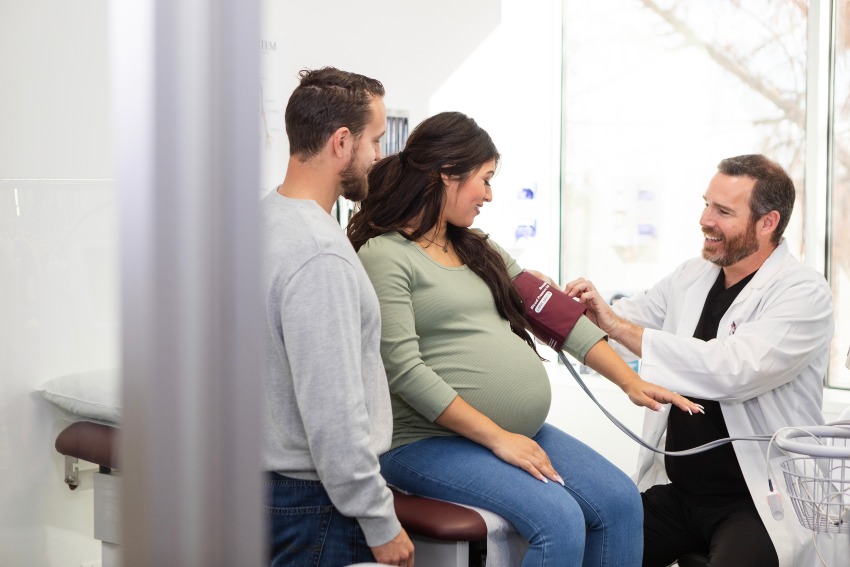 A doctor examines a pregnant woman focusing on pregnancy in her 40s in San Diego, CA