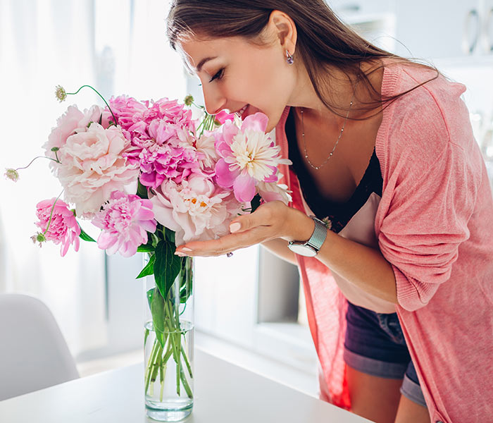 a girl smelling flowers