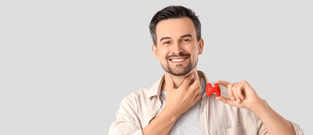 Handsome,Man,With,Thyroid,Gland,Model,On,Grey,Background